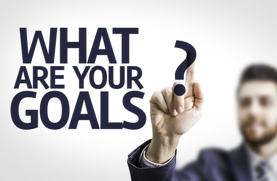 Business man pointing to transparent board with text What are Your Goals?.jpeg