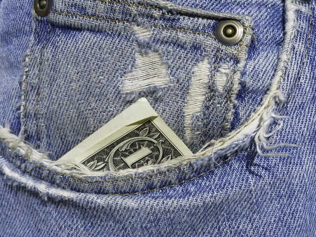 Down to the last dollar in frayed right pocket of blue jeans.jpeg