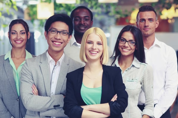 Happy group of co-workers standing in office