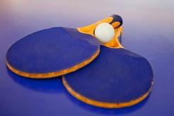 Ping pong set with two blue rackets and a white ball.jpeg