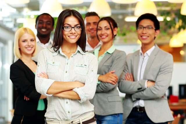 Smiling group of co-workers standing in office.jpeg