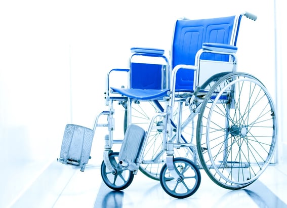 Wheelchair at the entrance of a hospital over a white background.jpeg